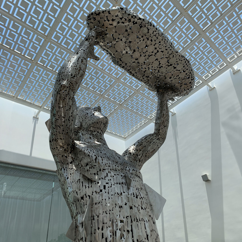 Monumental stainless steel sculpture created from BFG Metal scrap - a woman lifting a child
