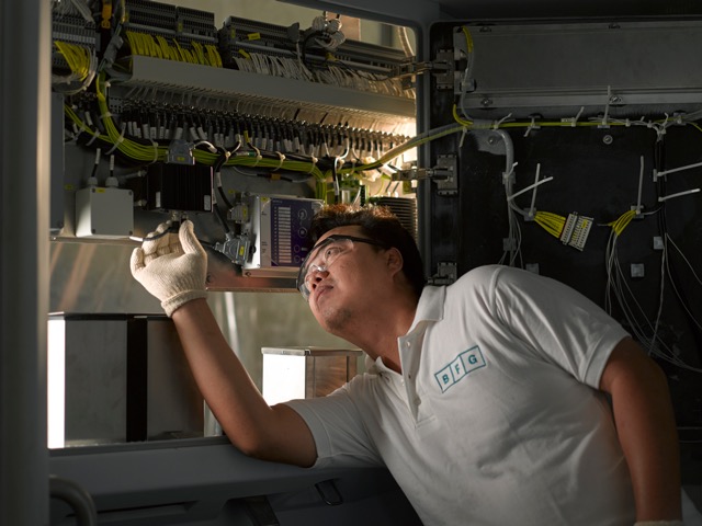 BFG technician installing electrical systems in rail cabin